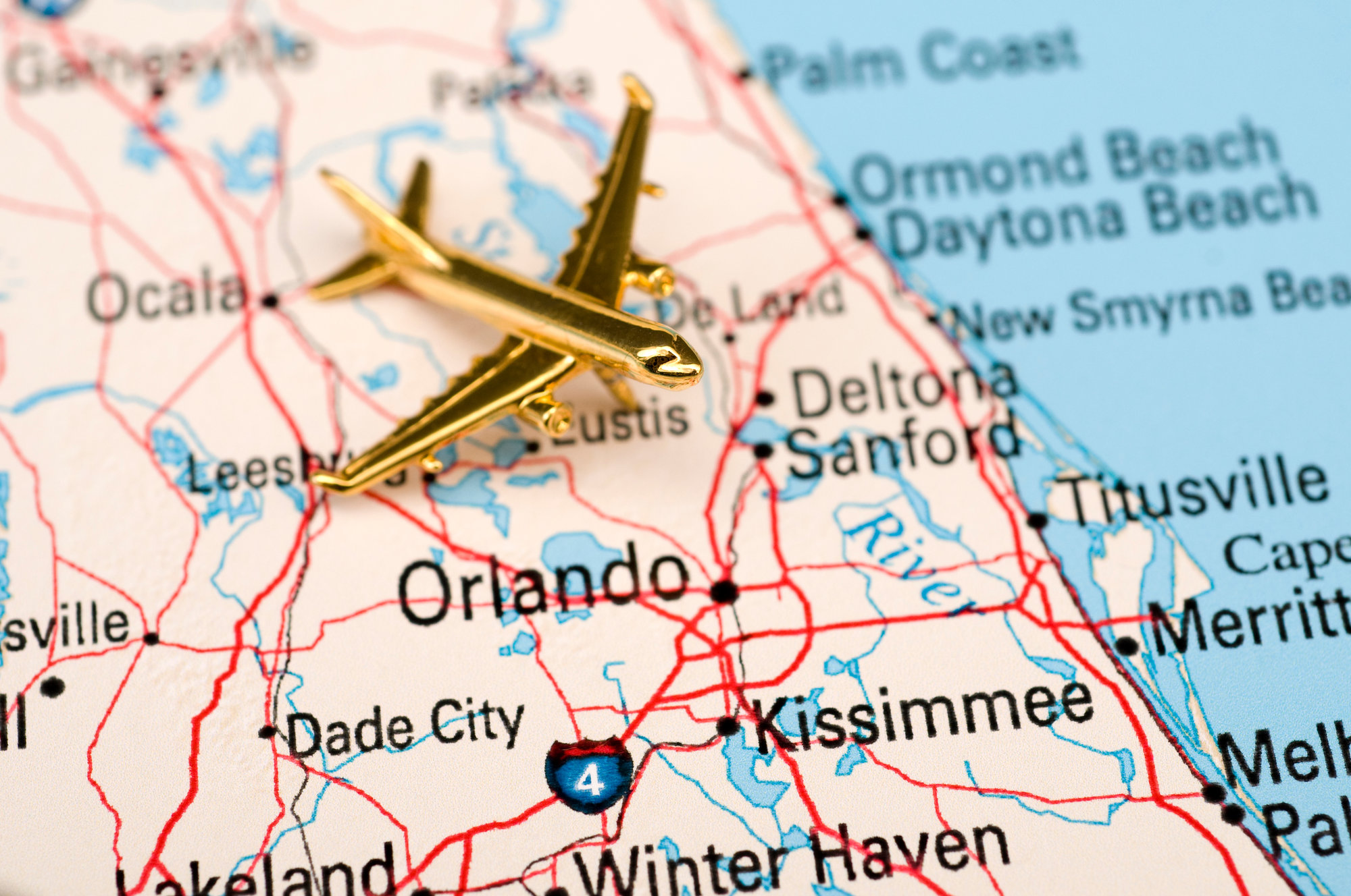 map of florida with orlando highlighted and gold plane